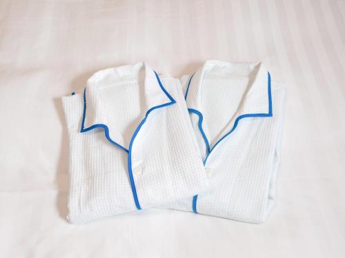 three white socks sitting on a white bed at Comfort Hotel Kushiro in Kushiro