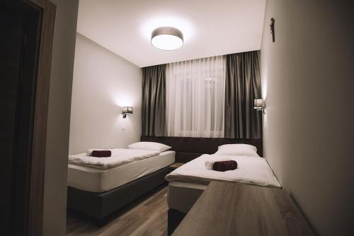 a room with two beds and a window at Villa Gabriel in Međugorje