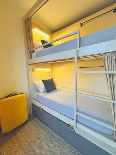 A bed or beds in a room at Strangerland Hostel