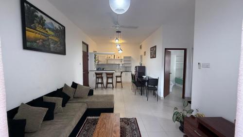 a living room with a couch and a table at Cozy Clifford Homagama in Homagama