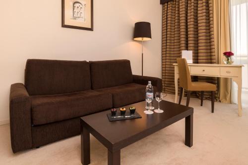 a living room with a couch and a coffee table at Hotel Garden Istra Plava Laguna in Umag