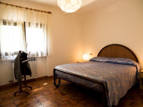 a bedroom with a bed and a chandelier at Casa Vacanze Boario in Boario Terme