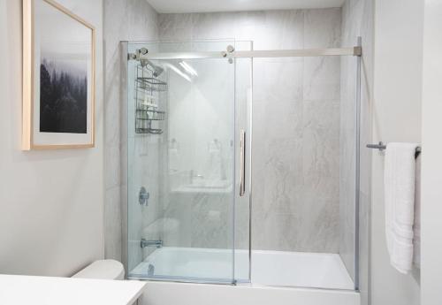 a bathroom with a shower with a glass door at Qs Hideaway in Mackenzie Village in Revelstoke