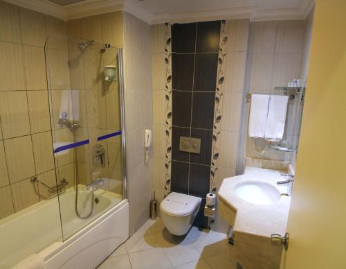 a bathroom with a toilet and a shower and a sink at Fun&Sun Smart Hane sun in Side