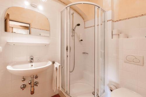 a bathroom with a shower and a sink and a toilet at Alimonte Romantic Appartements in Sankt Johann in Tirol