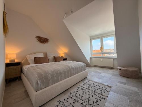 a bedroom with a large bed and a window at Wunderschöne Wohnung direkt am St Johanner Markt in Saarbrücken