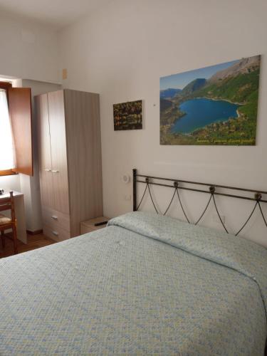 a bedroom with a bed and a view of a lake at La Casa di Rossella in Scanno