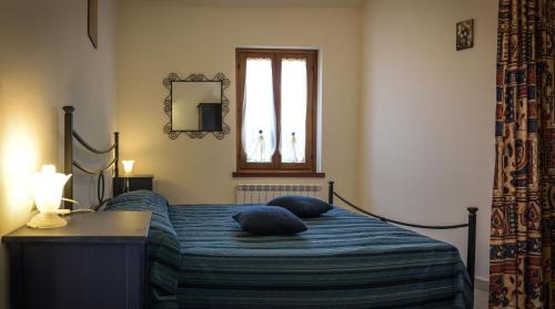Ένα ή περισσότερα κρεβάτια σε δωμάτιο στο Guest House Agriturismo i Conti