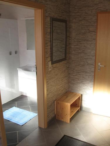 a bathroom with a sink and a wooden table at Ferienwohnung auf dem Bünberg in Bebra