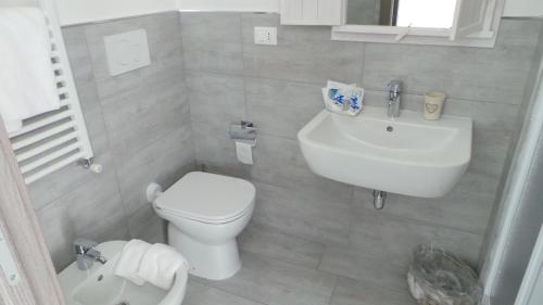 a bathroom with a white toilet and a sink at Carducci in Como