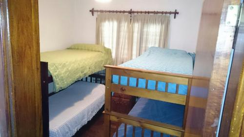 1 dormitorio con 2 literas y ventana en susana en La Falda