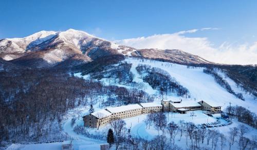 a building on a snowy mountain with snow covered mountains at Niseko Northern Resort, An'nupuri in Niseko