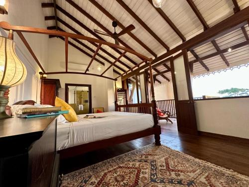 a bedroom with a bed and a table with a rug at Agni Luxury Beach Villa in Olagama