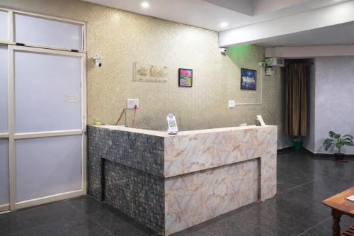 a lobby with a reception desk in a room at Hotel Golden Suites in Bangalore