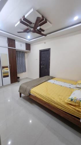 a bedroom with a bed and a ceiling fan at Kutir Stay Aaram in Secunderabad