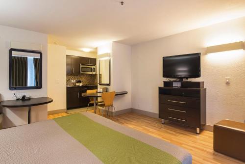 a hotel room with a bed and a flat screen tv at Studio 6-Concord, CA in Concord