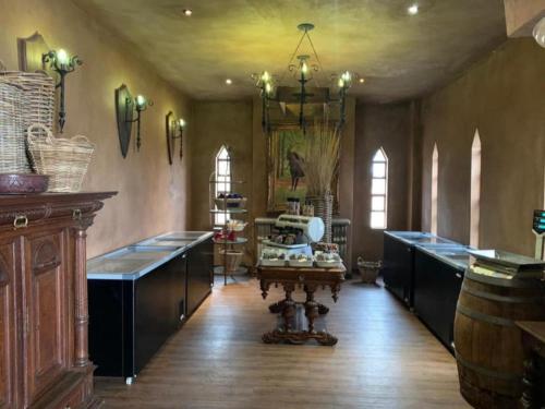a large room with a table and a chandelier at Castle de Wildt in Modimolle
