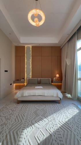 a bedroom with a large bed and a chandelier at The Moonridge Retreat in Sinādil
