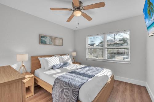 a bedroom with a bed and a ceiling fan at The Bungalows in St. Pete Beach