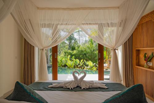 En eller flere senge i et værelse på Alankara Villa & Spa Ubud by Mahaprana