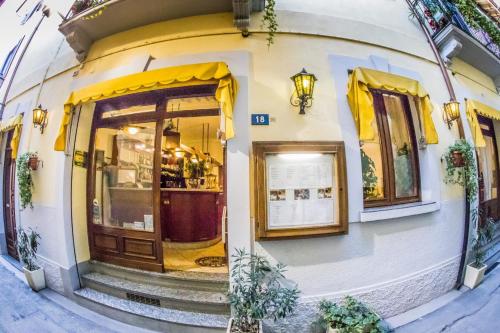 a building with a door and yellow curtains on it at La Belle Epoque in Aosta