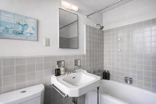a bathroom with a sink and a toilet and a mirror at Spacious 2 Bedroom 2 Bathroom Unit Great Location in Los Angeles