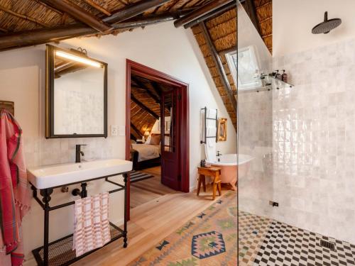 a bathroom with a sink and a shower at Yellowtail Finca in Plettenberg Bay