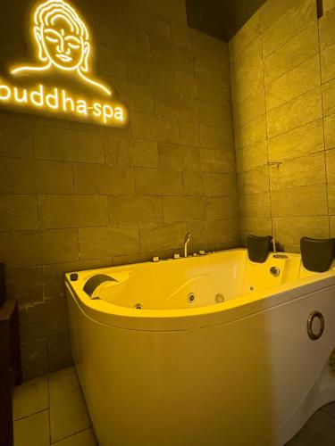a bath tub in a bathroom with a neon sign at Palazzo Rubina - Dimora mediterranea & SPA in Torre del Greco