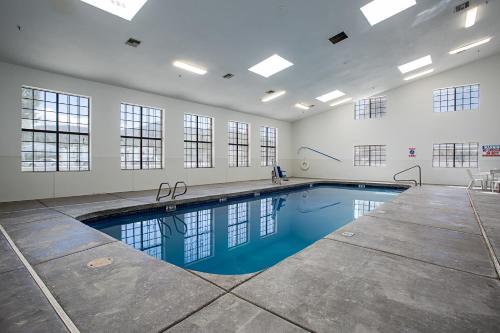 a large swimming pool in a white room with a swimming pool at Motel 6-Williams, AZ - West - Grand Canyon in Williams