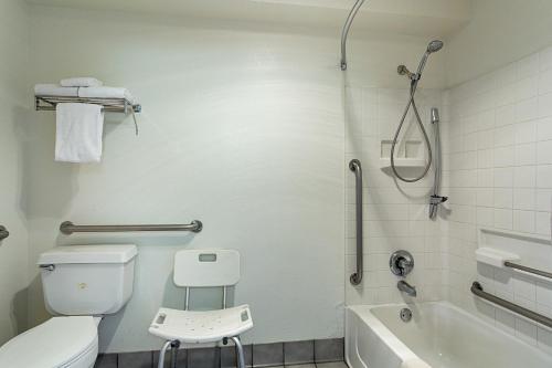 a bathroom with a toilet and a tub and a shower at Motel 6-Williams, AZ - West - Grand Canyon in Williams