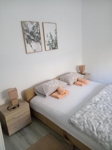 a bedroom with two twin beds and a night stand at Apartman Mira&Ahmet in Stolac