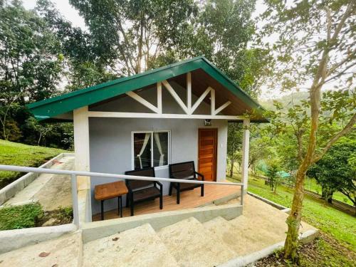 a small house with a green roof at The PineHill Farm in Tanay