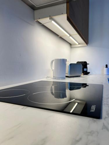 a kitchen with a counter with a coffee maker on it at La Petite Escapade-Free Parking in Liège