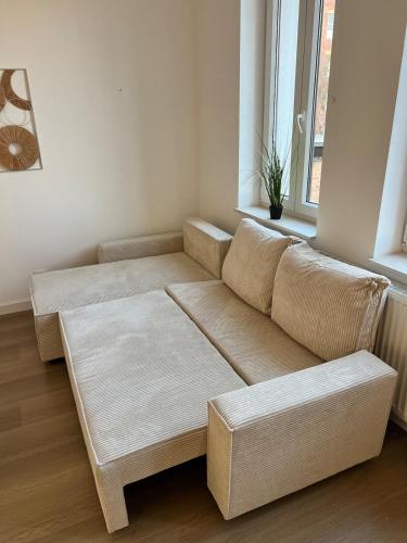 a living room with a couch and a window at La Petite Escapade-Free Parking in Liège