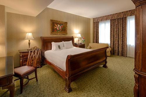 a bedroom with a bed and a chair in a room at Carnegie Hotel & Spa in Johnson City