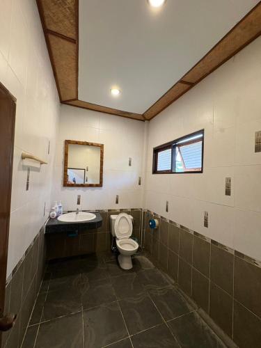 a bathroom with a toilet and a sink at Lanta White Rock Resort in Ko Lanta