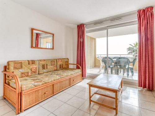 a living room with a couch and a table at Alizea Beach A N106 2P4 in Valras-Plage