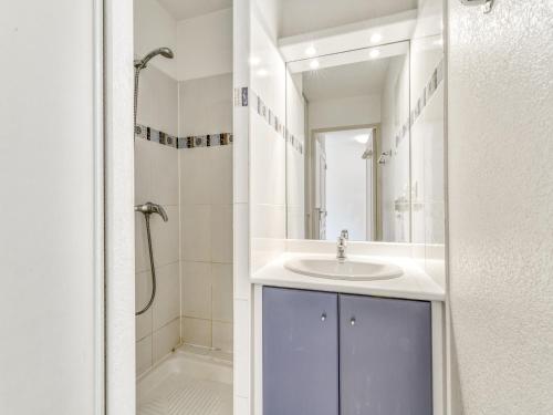 a white bathroom with a sink and a shower at Alizea Beach A N106 2P4 in Valras-Plage