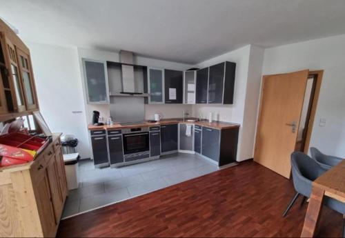 a kitchen with black cabinets and stainless steel appliances at Süße Marie 3 in Karlsruhe