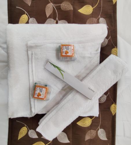 a close up of a white towel with two candles at RT RESIDENCY HOTEL and LODGE in Nandurbār