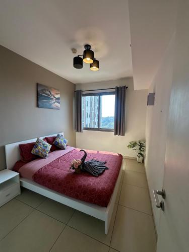 a bedroom with a bed with a bird on it at unixx seaview in Pattaya South