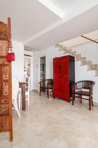 a living room with a red cabinet and a table at Rincón del Sur in Vejer de la Frontera