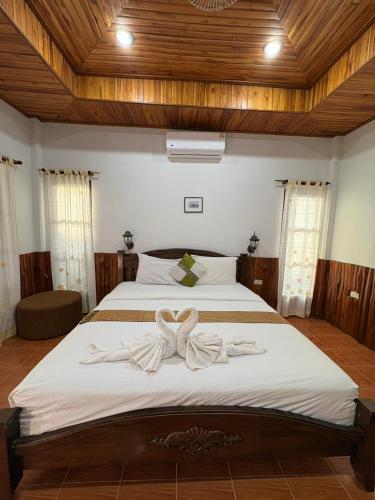 a bedroom with a bed with a bow on it at Lanta White Rock Resort in Ko Lanta