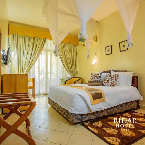 a bedroom with a large bed in a room at Ridar Hotel in Seeta