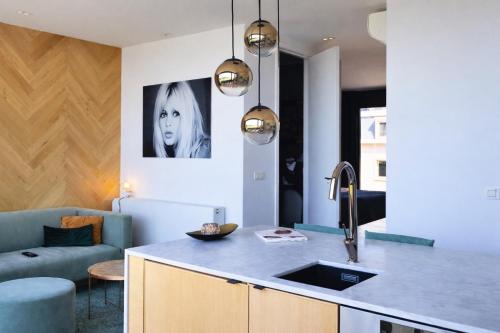 a kitchen with a sink and a counter top at SLEEP INN - Kaai11, Riverview Lofts & Suites in Antwerp