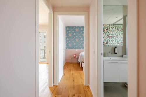 a hallway leading to a bedroom with a sink and a mirror at Le Dimore di Giò in Ortona
