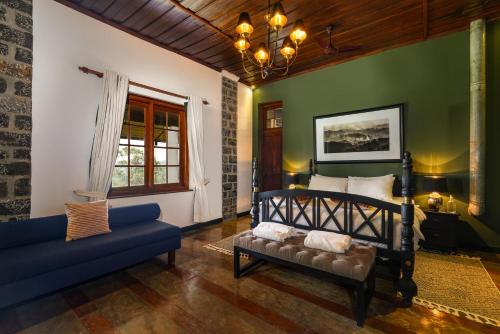 a bedroom with a bed and a couch at Garfield Bungalow by TONIK - 4BR Private Bungalow in Haputale - Mountain Views in Haputale