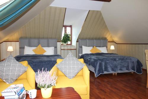 1 dormitorio con 2 camas, sofá y mesa en Tallinn City Apartments Residence en Tallin