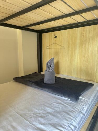 a bed with a hat sitting on top of it at Sunnies 24 in Phra Ae beach