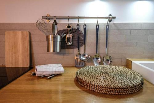 a kitchen with a rug on the floor next to a sink at Demeure Terrisse Les Studios in Marseillan